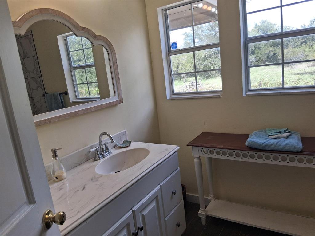 1584 Kelly Road, Unit A Aledo, TX 76008 - Photo 13 of 15 a bathroom with a sink a mirror and a window