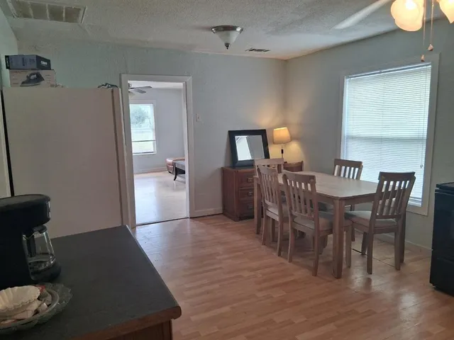 a view of a dining room with furniture and wooden floor