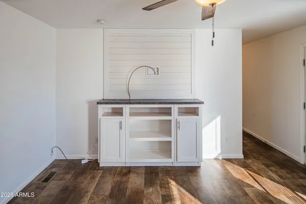 a view of a room with wooden floor