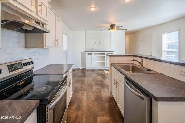 a kitchen that has a sink and a stove