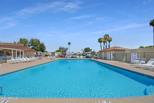 a front view of a house with swimming pool having outdoor seating