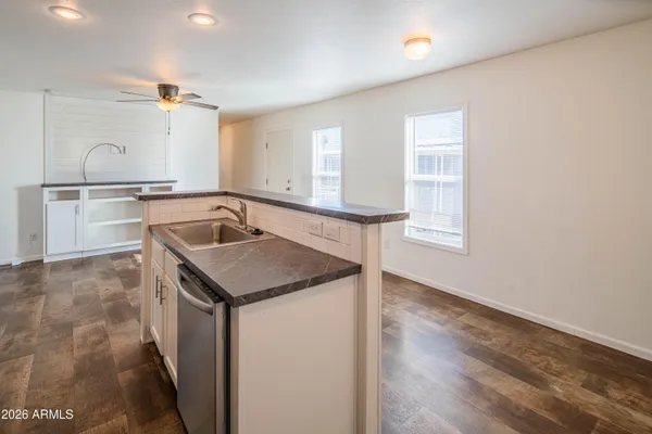 a kitchen with a sink stove and cabinets