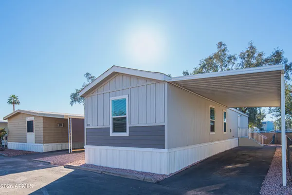 a front view of house with yard and trees in the background