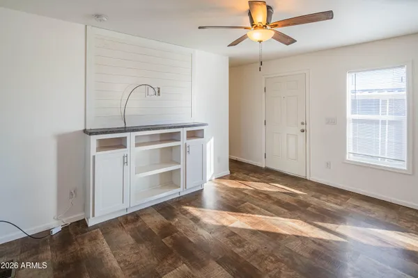 a view of a bedroom with a ceiling fan and window