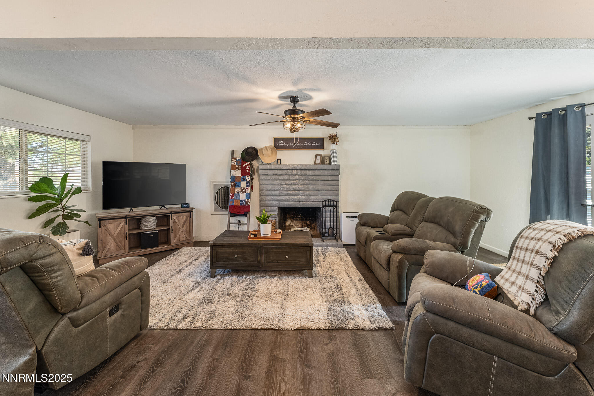 295 Palace Drive Reno, NV 89506 - Photo 8 of 26 a living room with furniture a flat screen tv and a fireplace