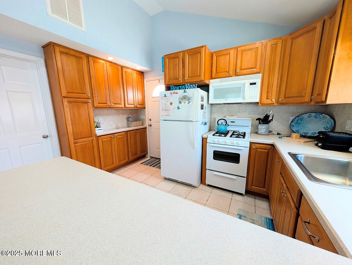 31 East Cormorant Way Lavallette, NJ 08735 - Photo 12 of 22 a kitchen with a sink a stove and refrigerator