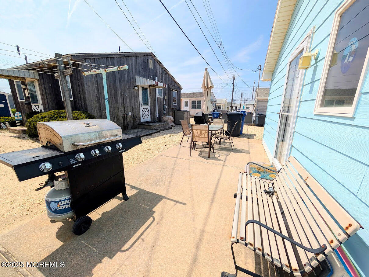 31 East Cormorant Way Lavallette, NJ 08735 - Photo 21 of 22 a view of a patio with table and chairs stove and wooden floor