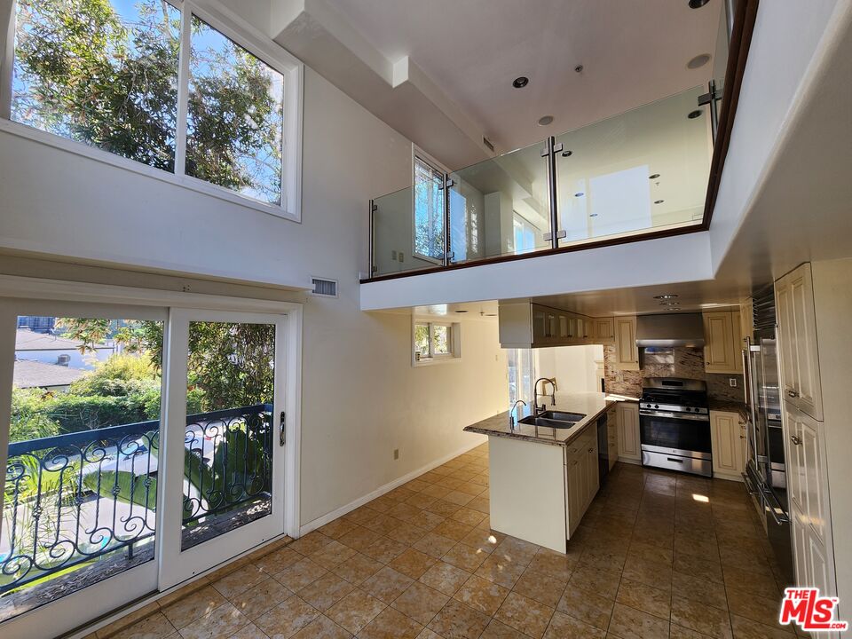 Almayo Avenue Los Angeles, CA 90064 - Photo 12 of 35 a kitchen with stainless steel appliances kitchen island granite countertop a refrigerator and stove