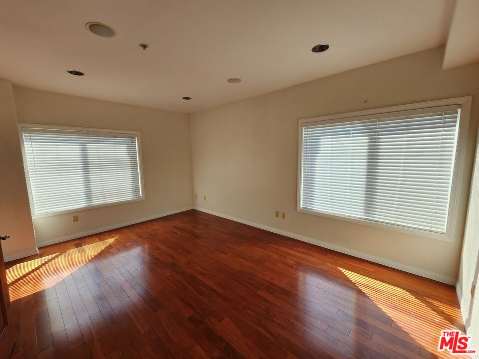 Almayo Avenue Los Angeles, CA 90064 - Photo 16 of 35 a view of an empty room with wooden floor and a window