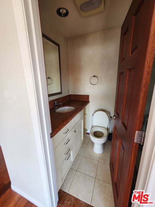 Almayo Avenue Los Angeles, CA 90064 - Photo 25 of 35 a bathroom with a granite countertop toilet and a sink