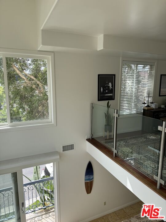 Almayo Avenue Los Angeles, CA 90064 - Photo 32 of 35 a view of a kitchen with a sink wooden cabinets and a floor to ceiling window