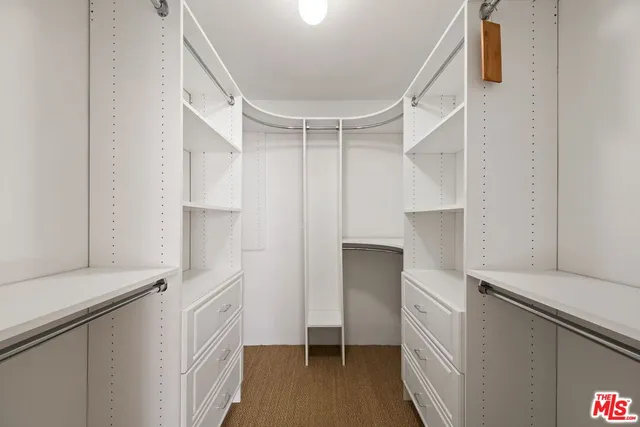 a view of walk in closet with white walls