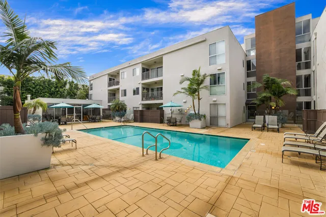 a view of a house with swimming pool and sitting area