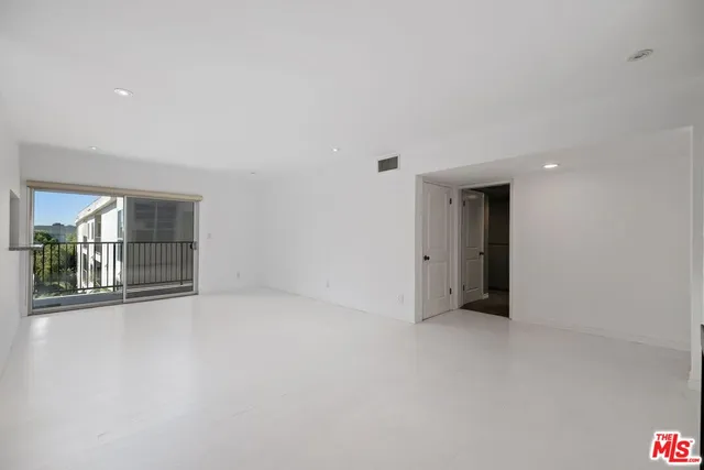 wooden floor in an empty room with windows