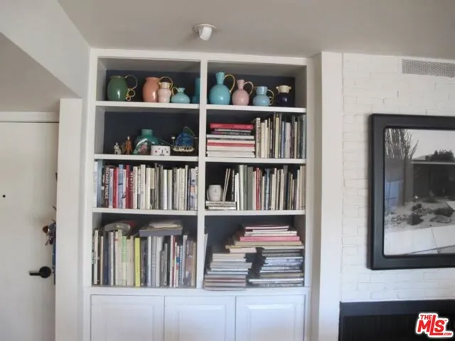 a shelf with books and knick knacks on it