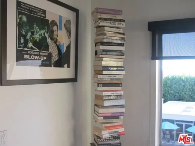 a view of a bedroom with a bed and a window