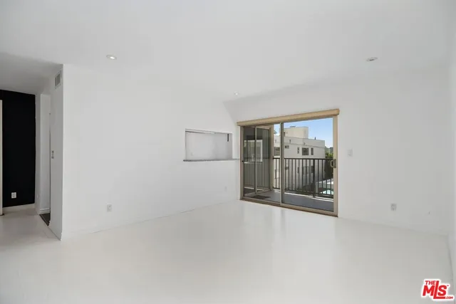 an empty room with glass door and glass door