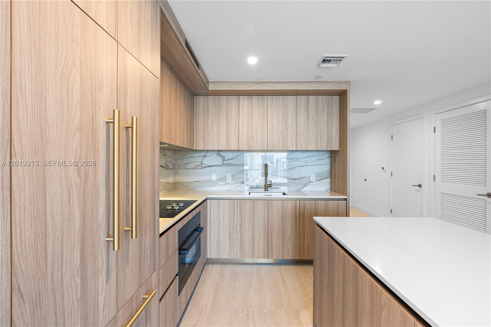77 Southeast 5th, Unit 3702 Miami, FL 33131 - Photo 5 of 63 a kitchen with stainless steel appliances a white cabinets and sink