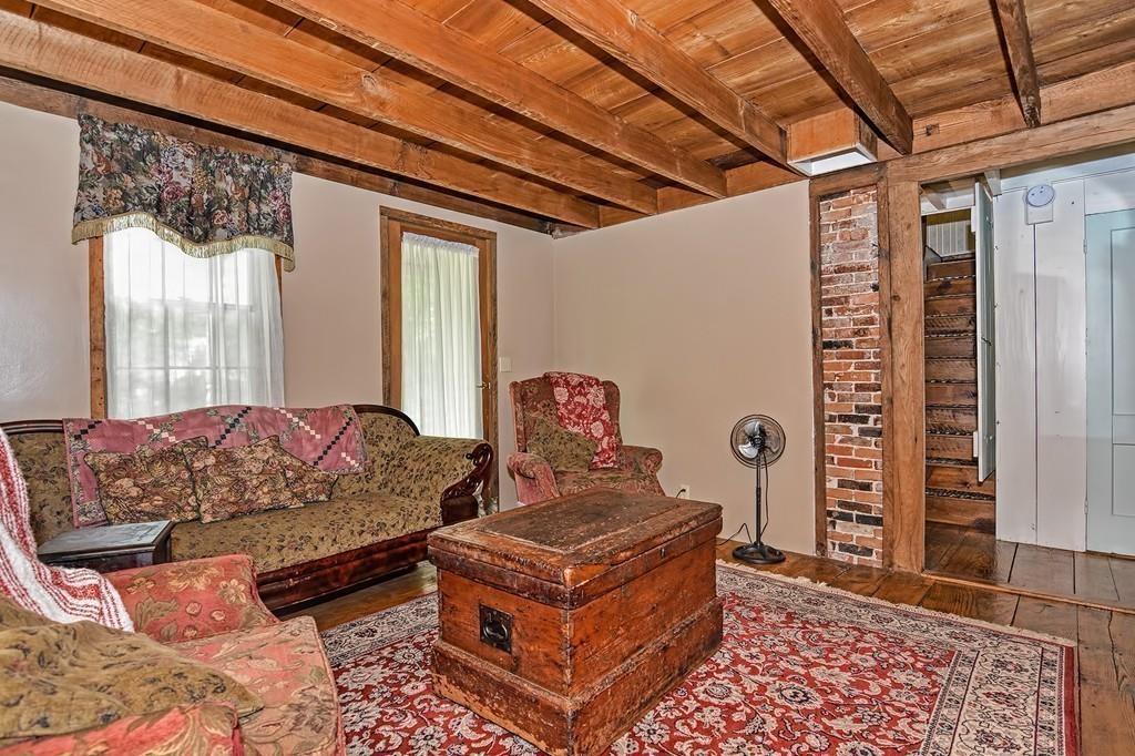 81 Warren Road Brimfield, MA 01010 - Photo 11 of 42 a living room with furniture a rug and a window