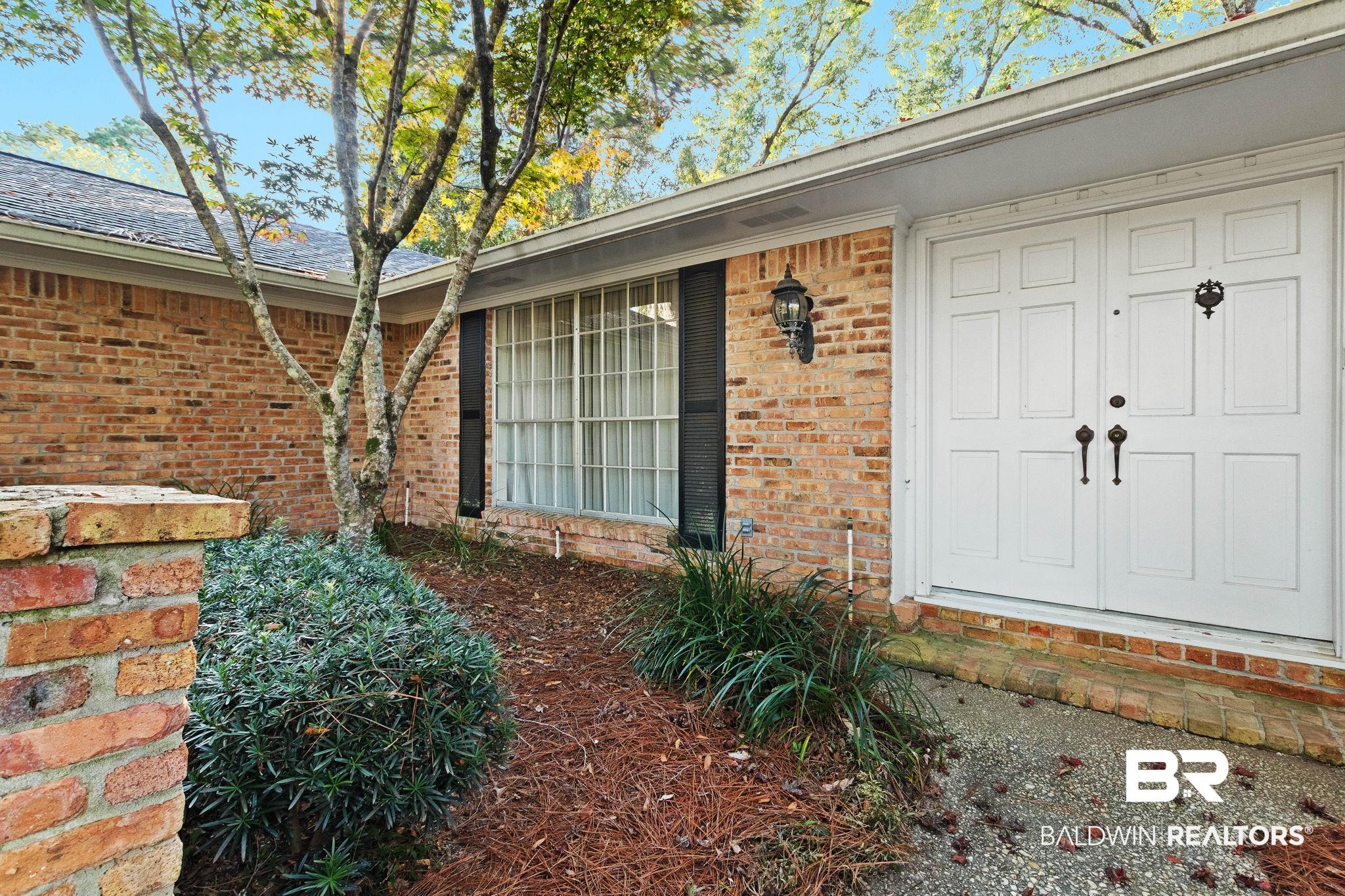 752 Evergreen Street Fairhope, AL 36532 - Photo 83 of 100 View of exterior entry featuring brick siding