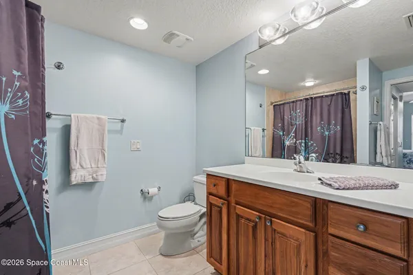 a bedroom with bed and a large window