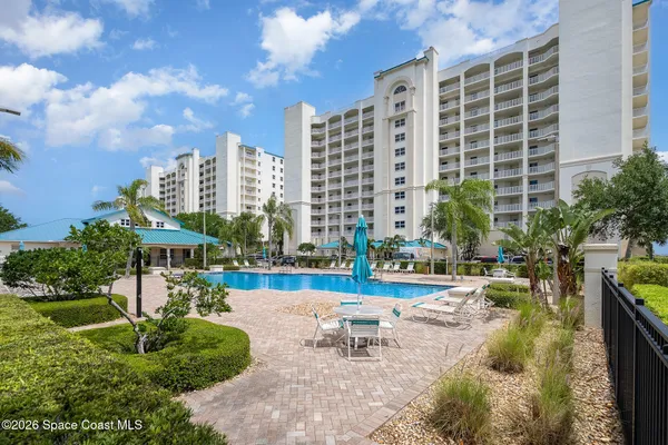 a view of swimming pool with outdoor seating and city view