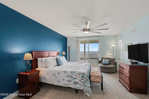a dining room with furniture and a large window