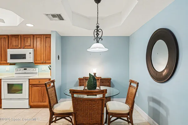a large kitchen with a table and chairs in it