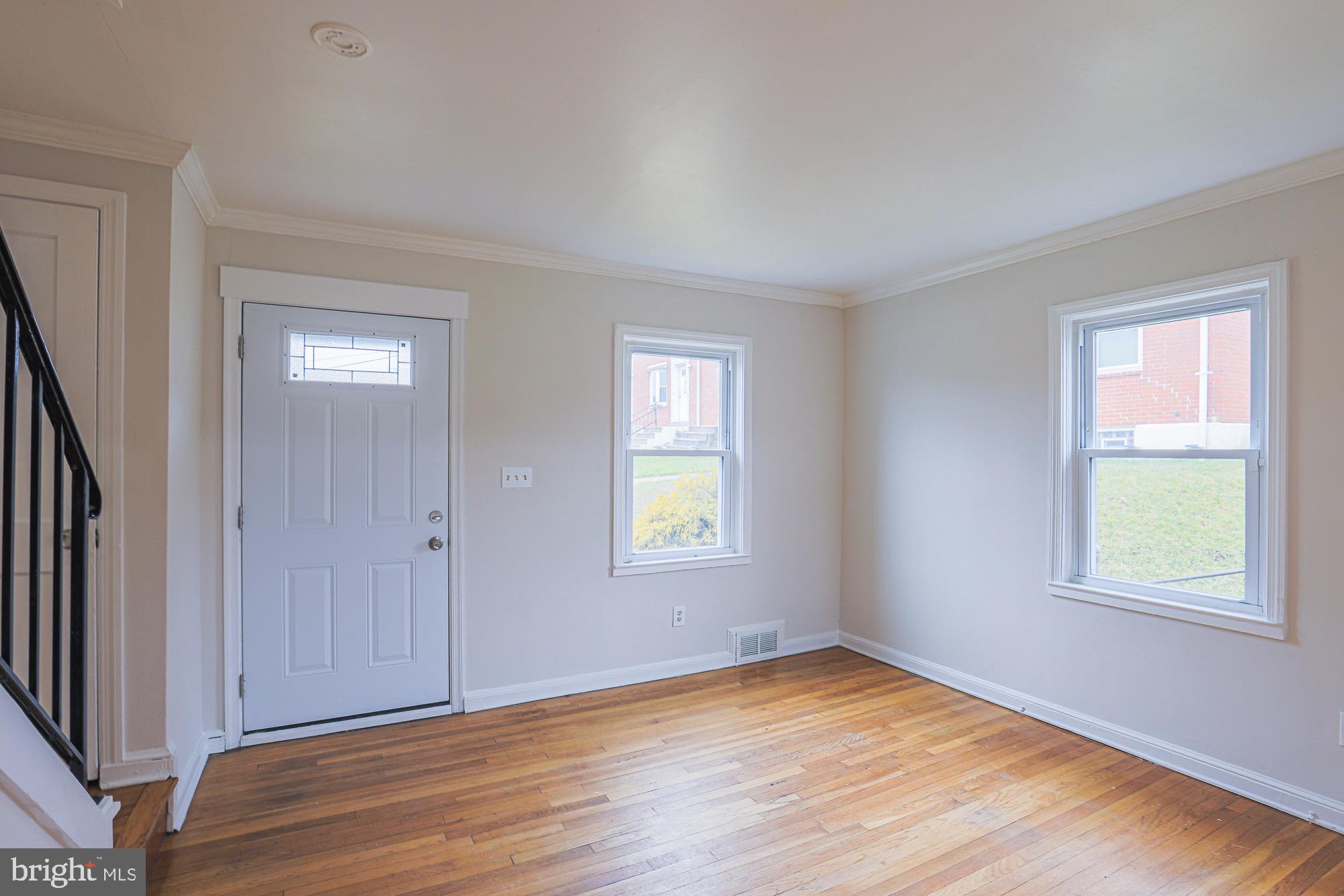 1022 Cameron Road Baltimore, MD 21212 - Photo 4 of 21 an empty room with window and wooden floor