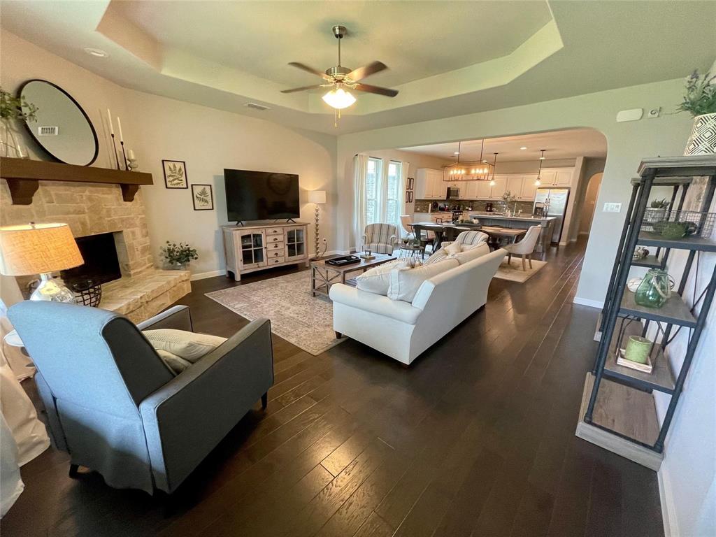 1904 Cardinal Way Argyle, TX 76226 - Photo 4 of 17 a living room with furniture a flat screen tv and a fireplace