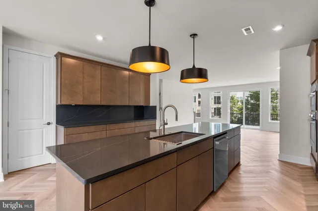 a kitchen with cabinets and chandelier