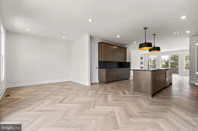 a view of kitchen with refrigerator and window