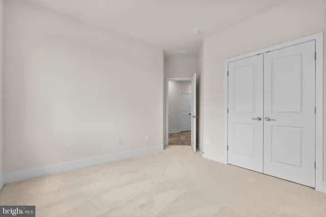 a view of an empty room and closet area