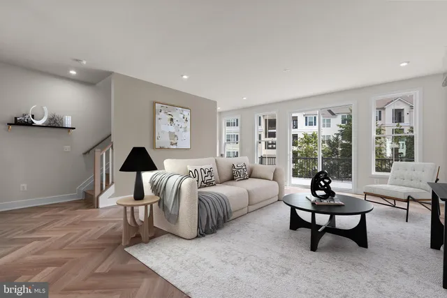 a bedroom with furniture and a large window