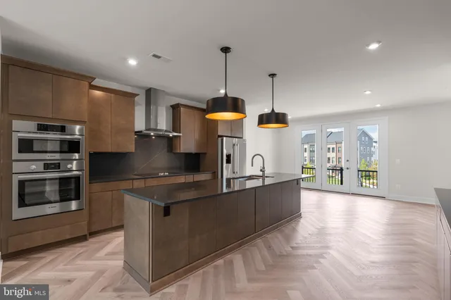 a kitchen with stainless steel appliances granite countertop a stove and a sink
