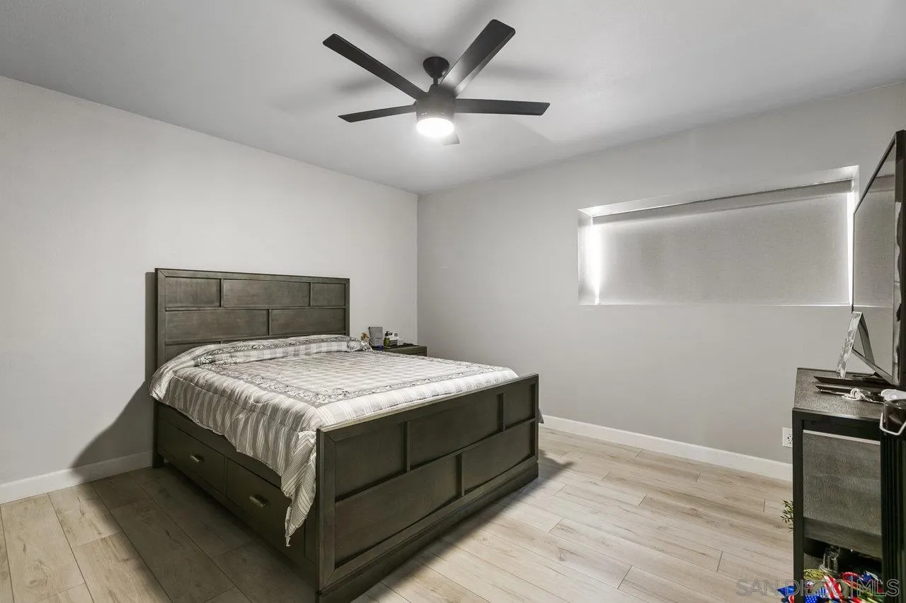 6381 Rancho Mission Road, Unit 6 San Diego, CA 92108 - Photo 16 of 30 a bedroom with a bed and a ceiling fan