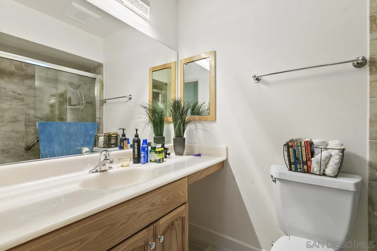 6381 Rancho Mission Road, Unit 6 San Diego, CA 92108 - Photo 18 of 30 a bathroom with a sink and a mirror