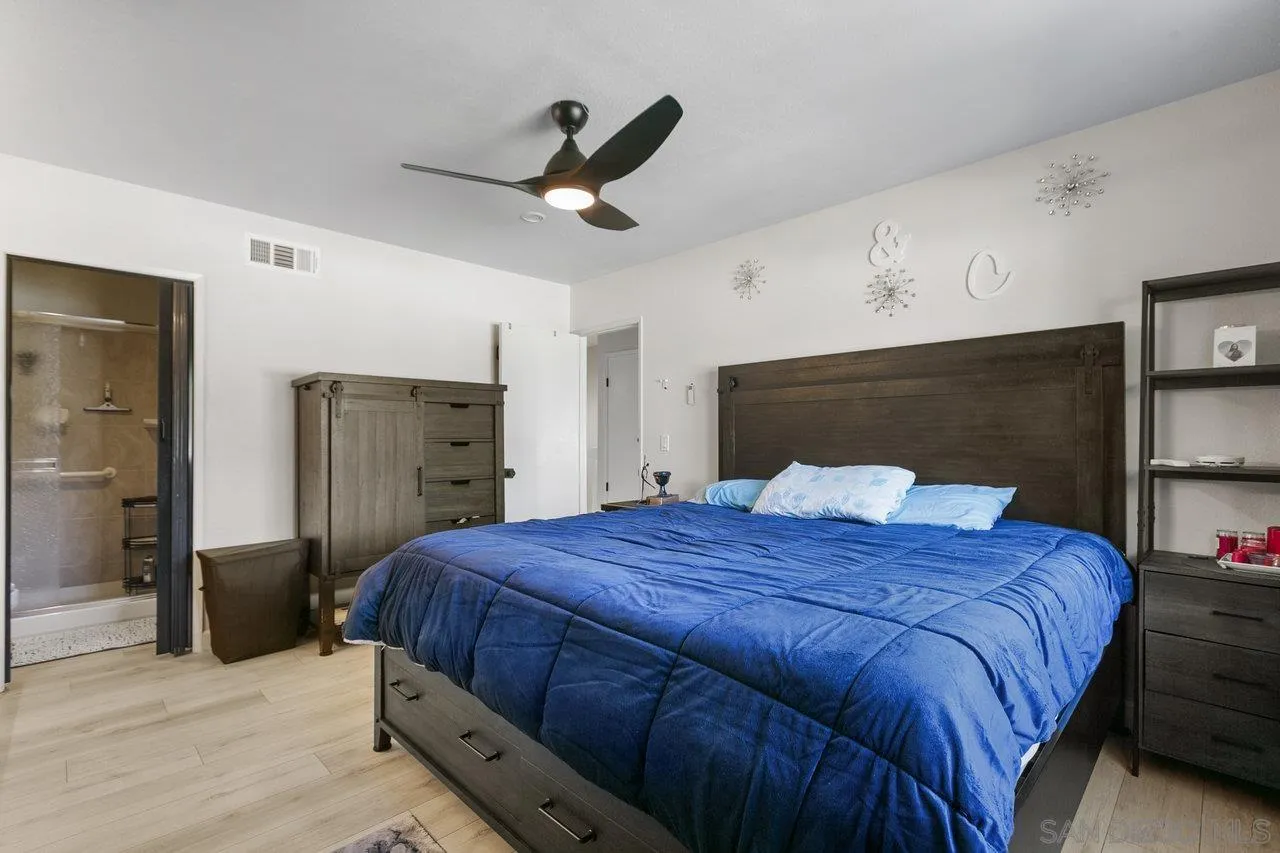 6381 Rancho Mission Road, Unit 6 San Diego, CA 92108 - Photo 20 of 30 a bedroom with a bed and a ceiling fan