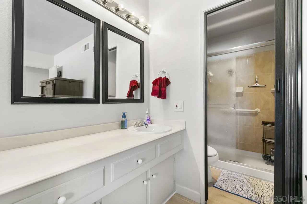 6381 Rancho Mission Road, Unit 6 San Diego, CA 92108 - Photo 21 of 30 a bathroom with a bathtub sink vanity and mirror