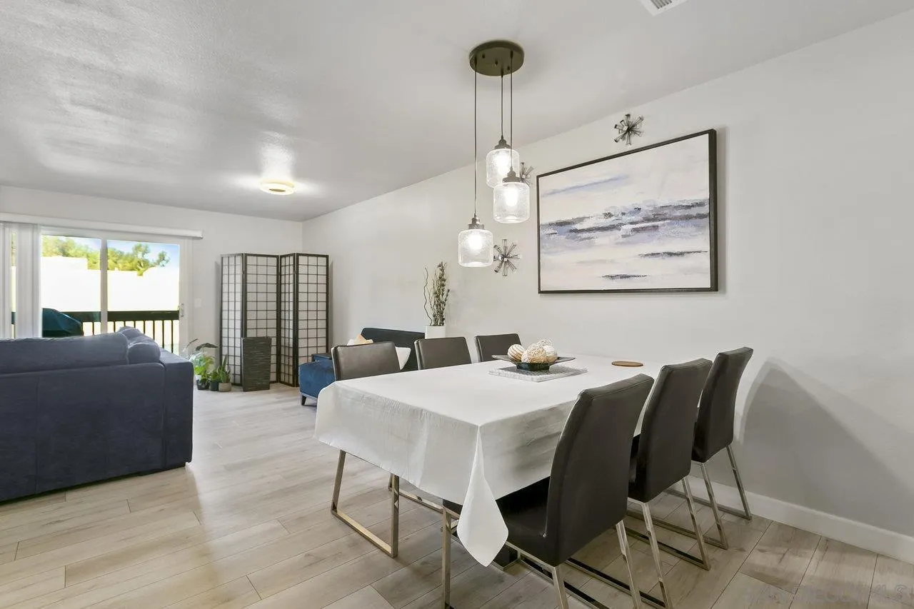 6381 Rancho Mission Road, Unit 6 San Diego, CA 92108 - Photo 7 of 30 a view of a dining room with furniture window and wooden floor