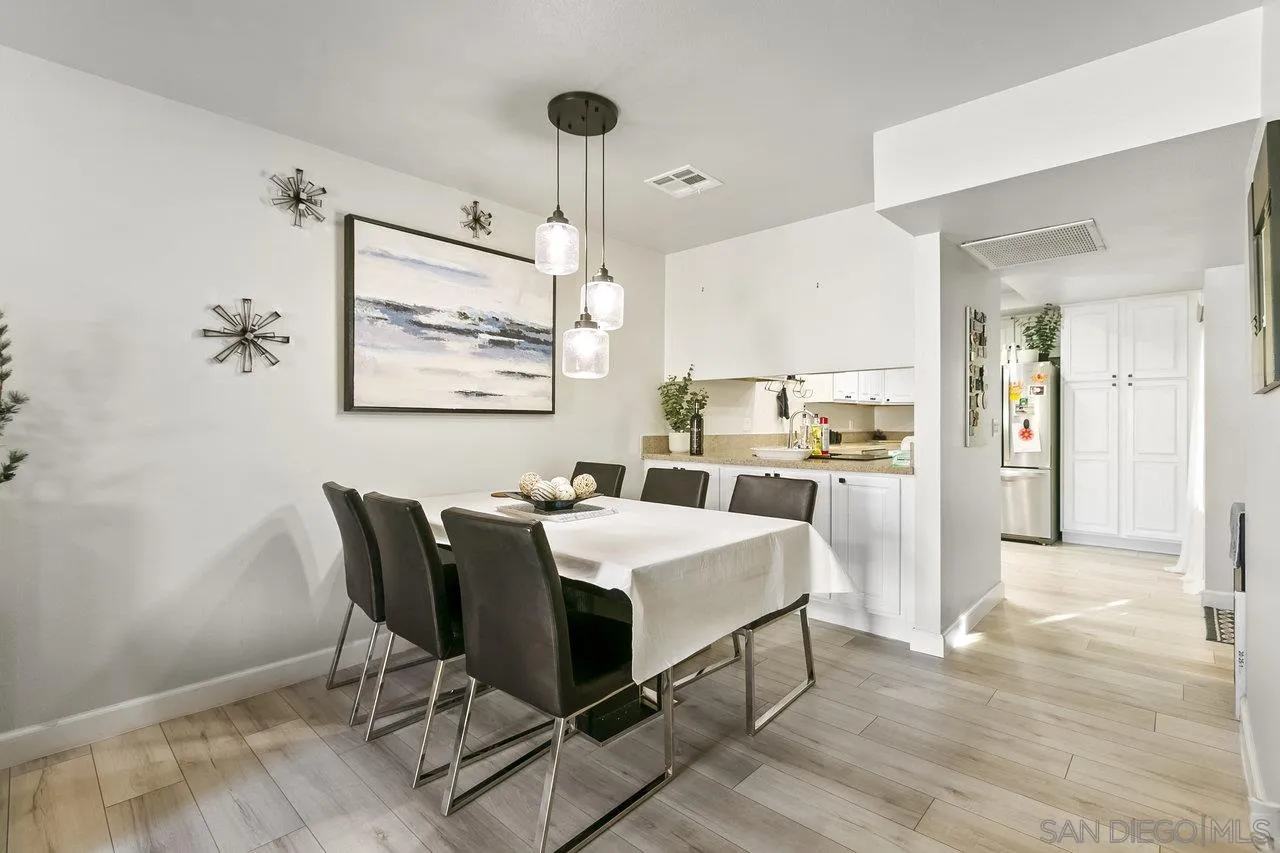 6381 Rancho Mission Road, Unit 6 San Diego, CA 92108 - Photo 8 of 30 a view of a dining room with furniture and a chandelier