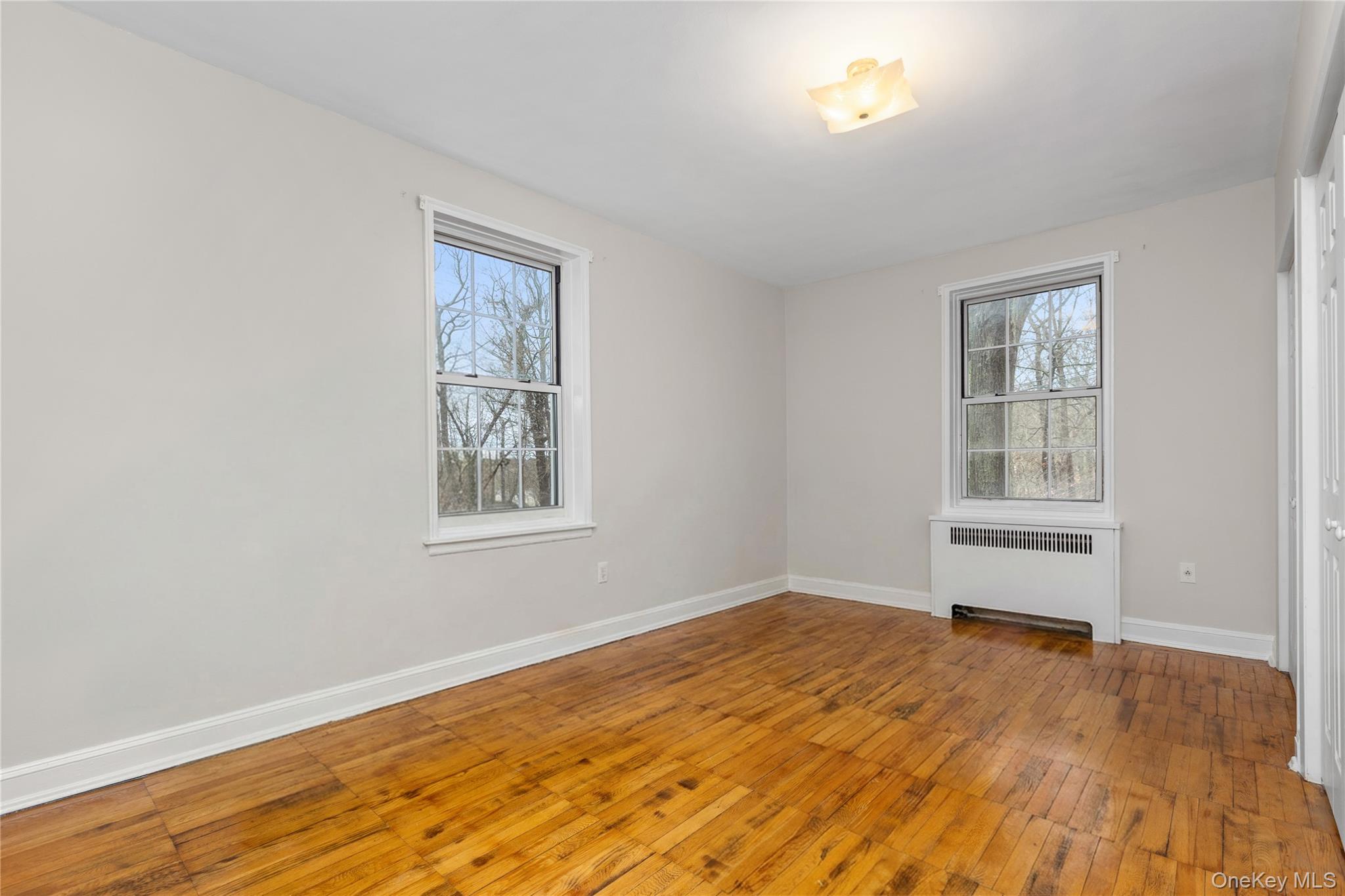 60 Pinewood Road, Unit 1B Hartsdale, NY 10530 - Photo 13 of 27 Spacious bedroom featuring hardwood flooring, 4 large closets and a healthy amount of natural light.