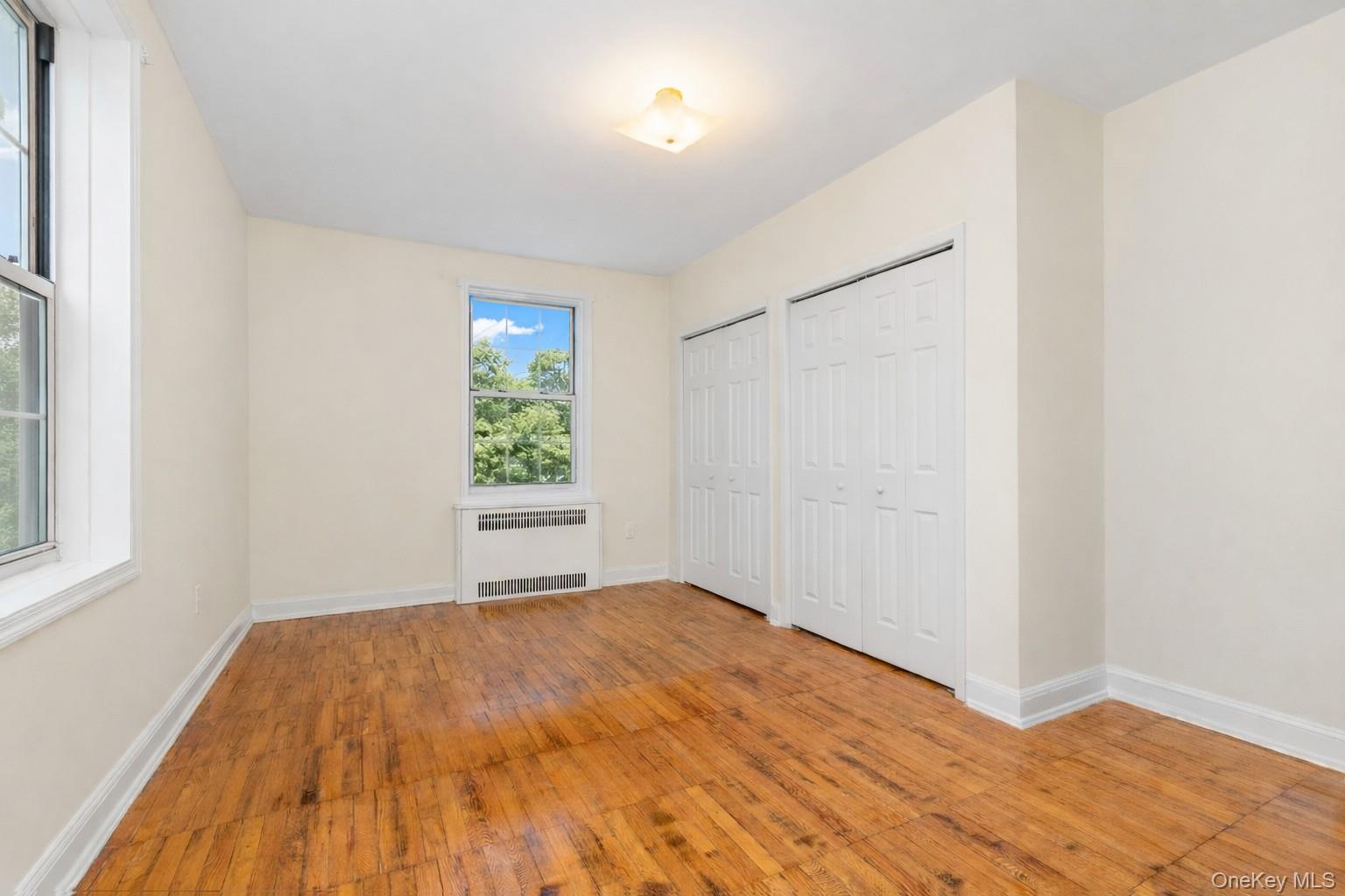 60 Pinewood Road, Unit 1B Hartsdale, NY 10530 - Photo 14 of 27 Spacious bedroom featuring a total of 4 closets and hardwood flooring.