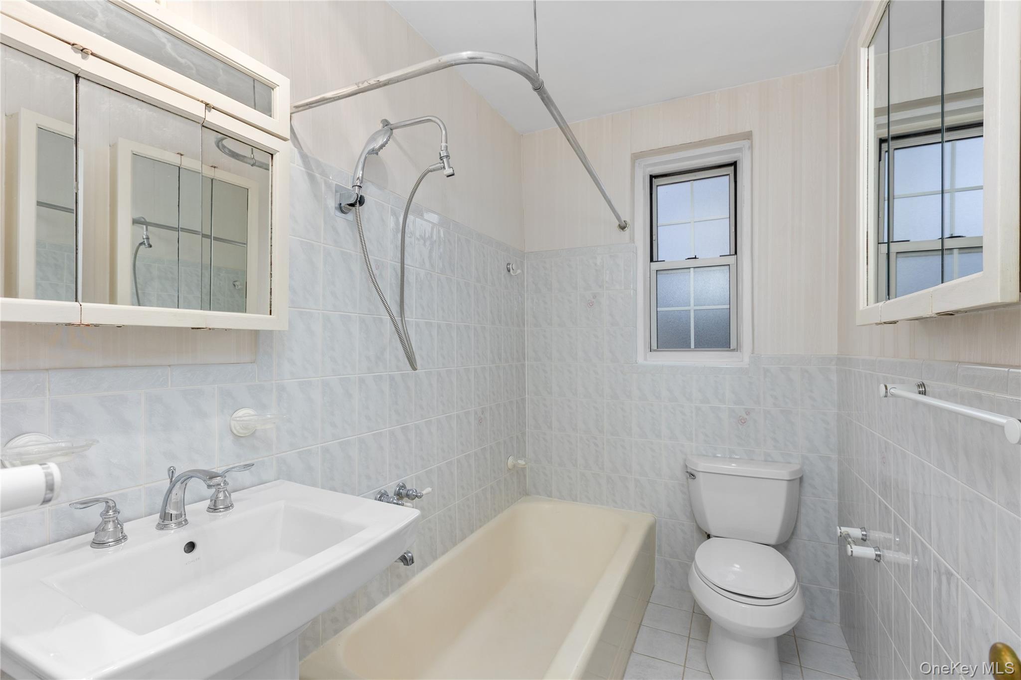 60 Pinewood Road, Unit 1B Hartsdale, NY 10530 - Photo 16 of 27 Full bathroom featuring tile walls, shower / tub combination, and tile patterned flooring.