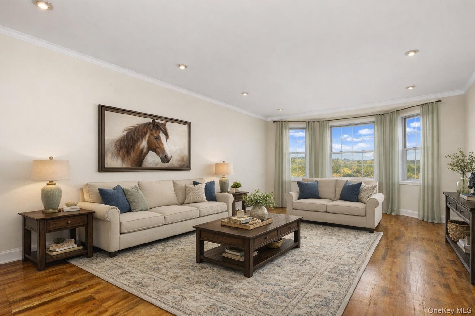 60 Pinewood Road, Unit 1B Hartsdale, NY 10530 - Photo 3 of 27 Virtually staged living room with a southern exposure, hardwood flooring, crown molding, and recessed lighting.
