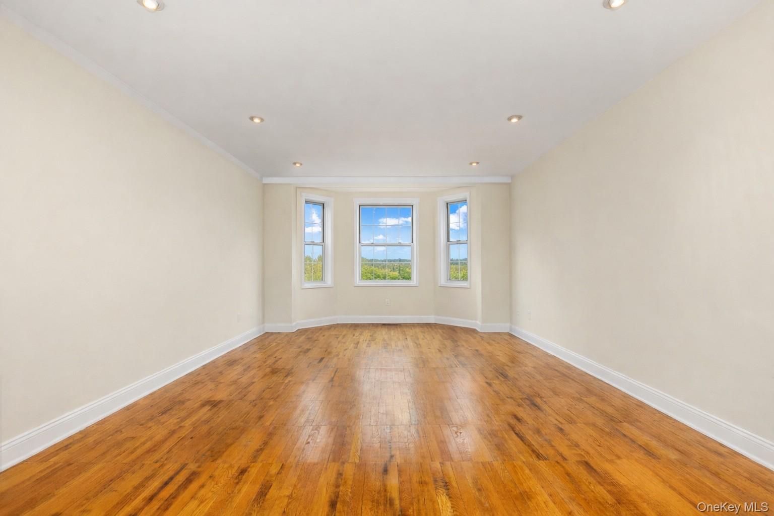 60 Pinewood Road, Unit 1B Hartsdale, NY 10530 - Photo 5 of 27 Large living room with hardwood flooring and recessed lighting.
