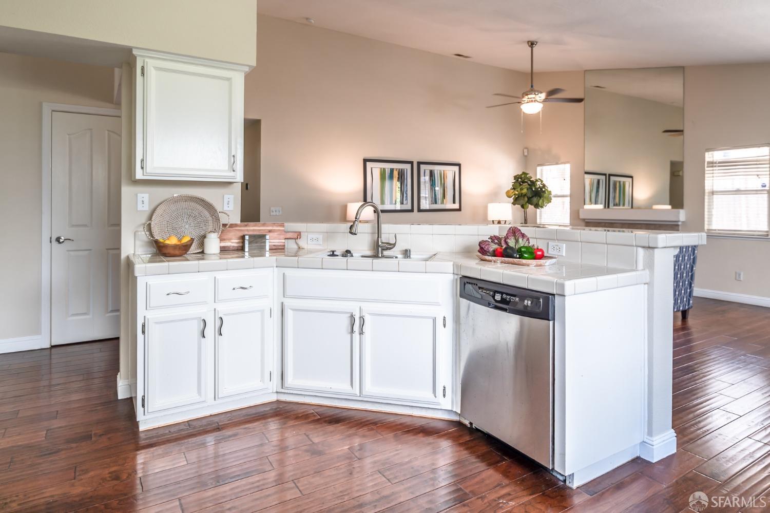 4603 Chelsea Drive Oakley, CA 94561 - Photo 9 of 36 a kitchen with kitchen island granite countertop a sink cabinets and wooden floor