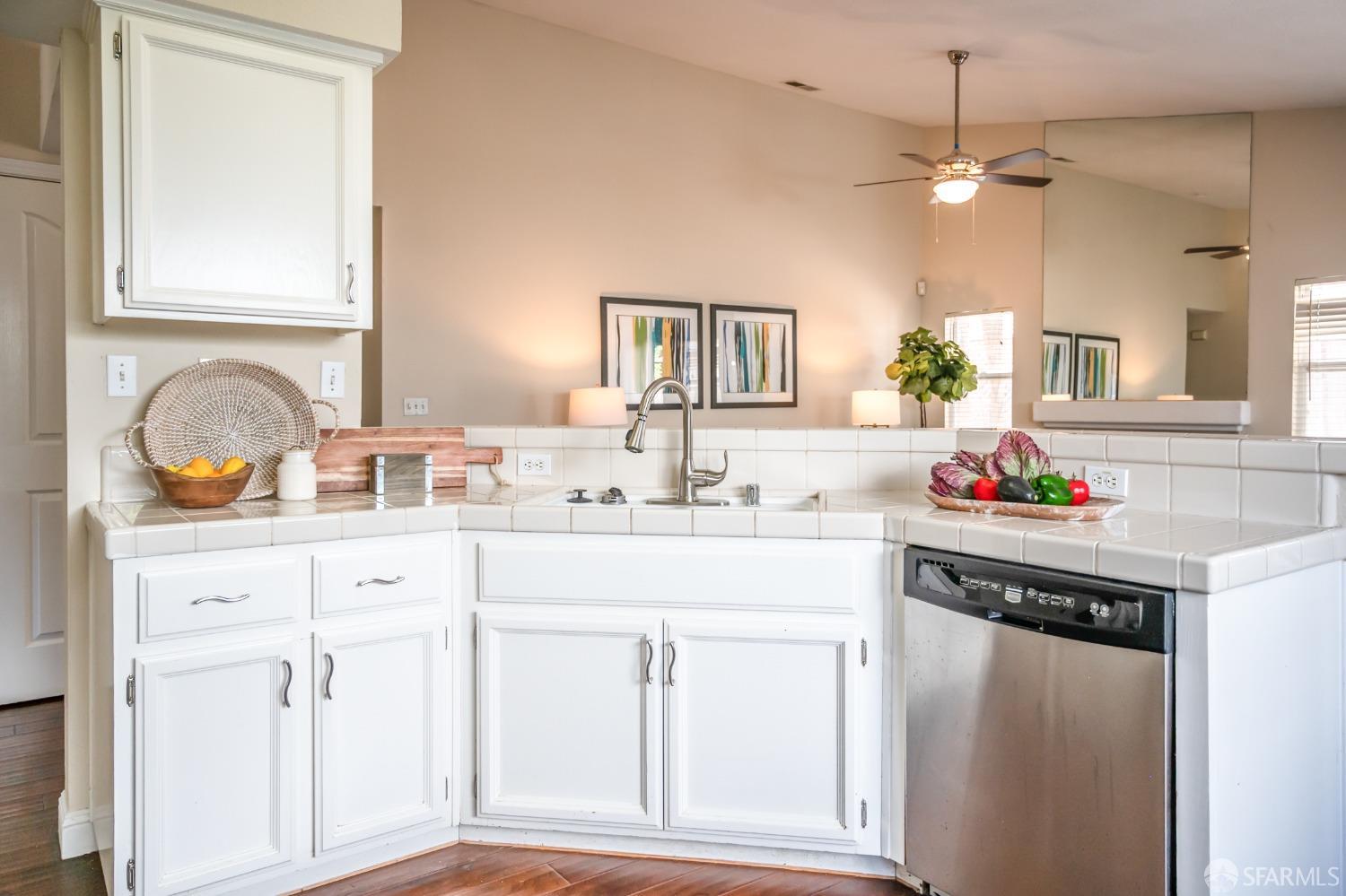4603 Chelsea Drive Oakley, CA 94561 - Photo 10 of 36 a kitchen with granite countertop white cabinets and white appliances