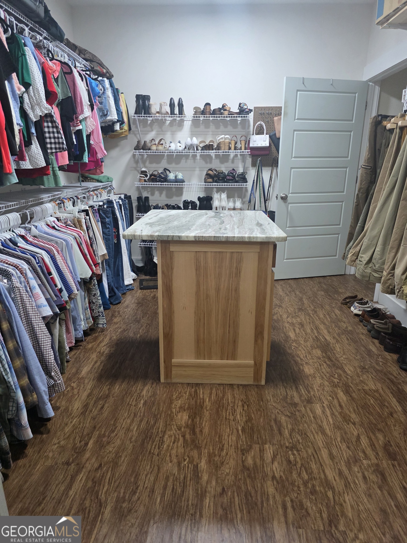 3060 Eatonton Road Madison, GA 30650 - Photo 30 of 65 a view of walk in closet with clothes and shoes