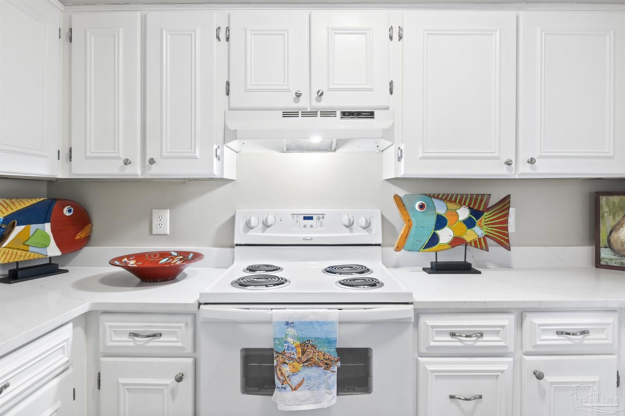 16470 Perdido Key Drive, Unit C24 Perdido Key, FL 32507 - Photo 11 of 48 a kitchen with white cabinets and white appliances